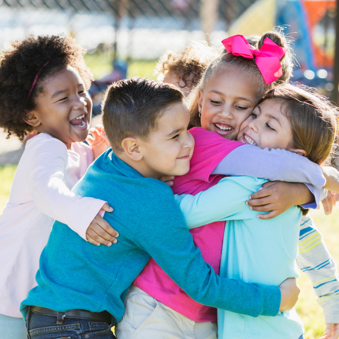 Kids hugging having fun at the playground